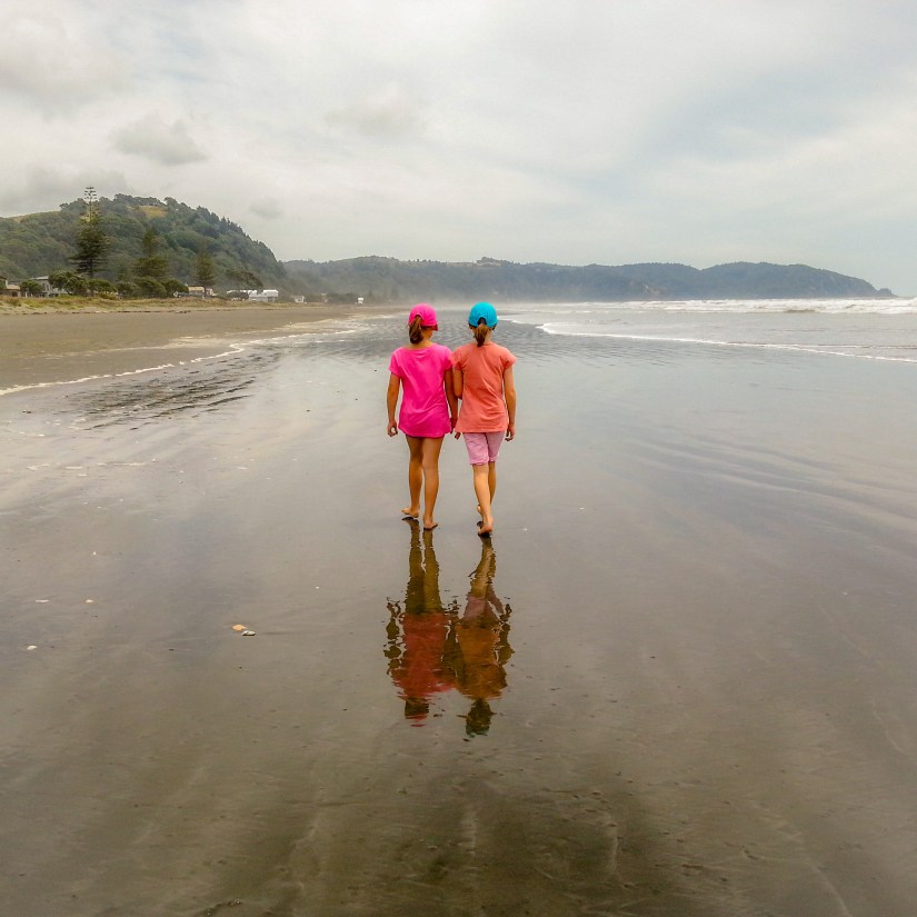 Madi and Paige walking along Ohope Beach